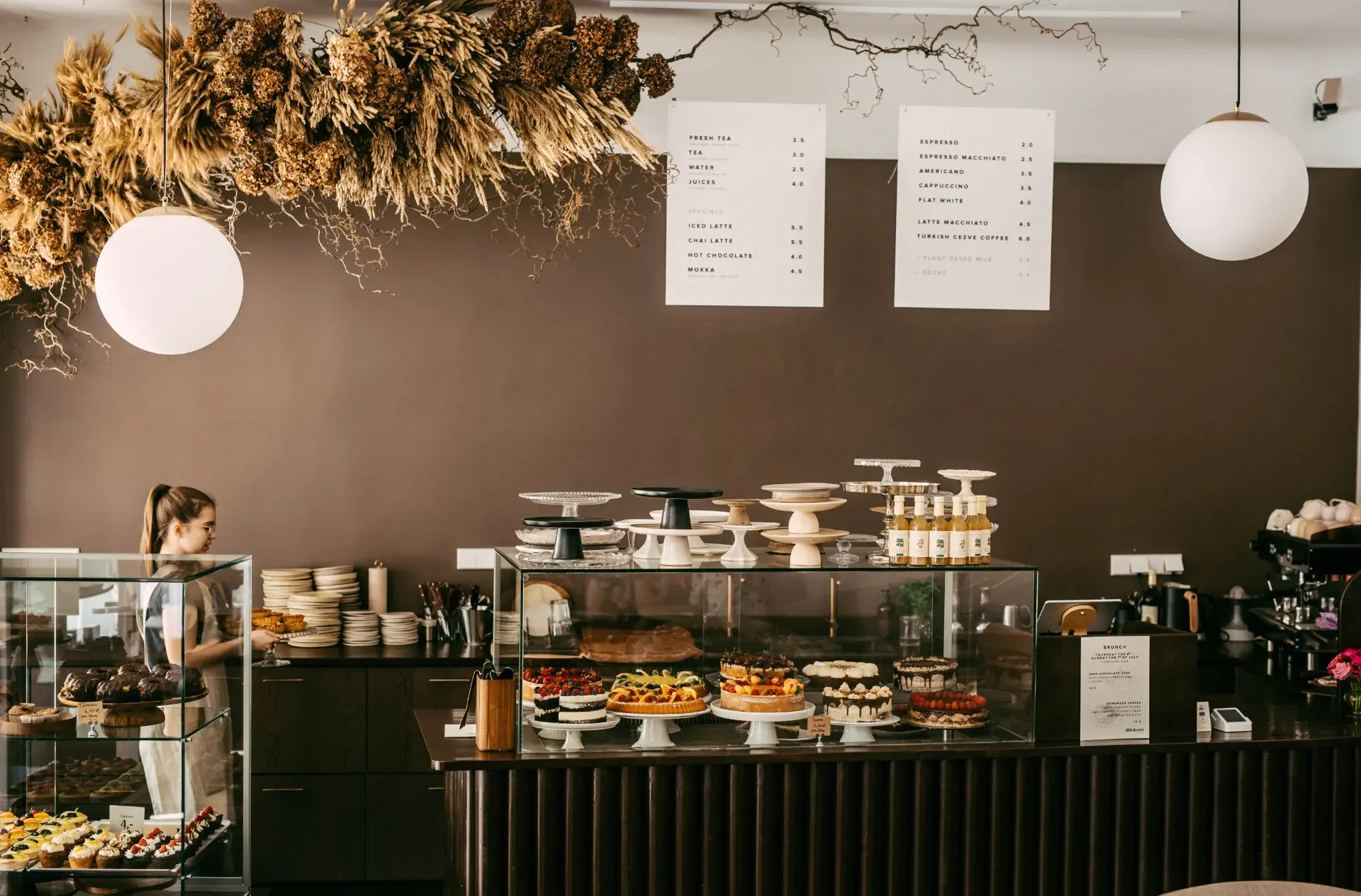 Elegant pastry display inside Dilekerei café in Berlin with artisan cakes, desserts and menu