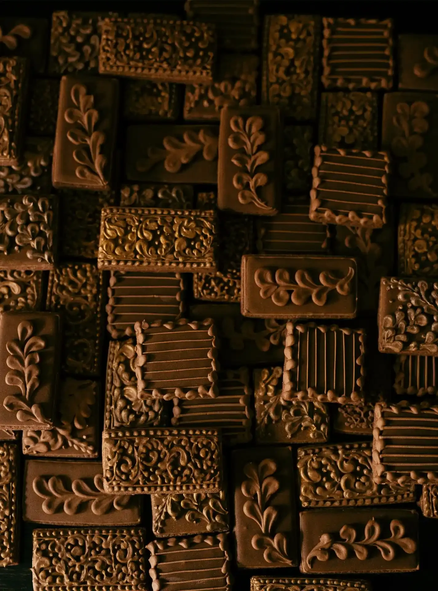 Various decorative chocolate bars with intricate designs and patterns.