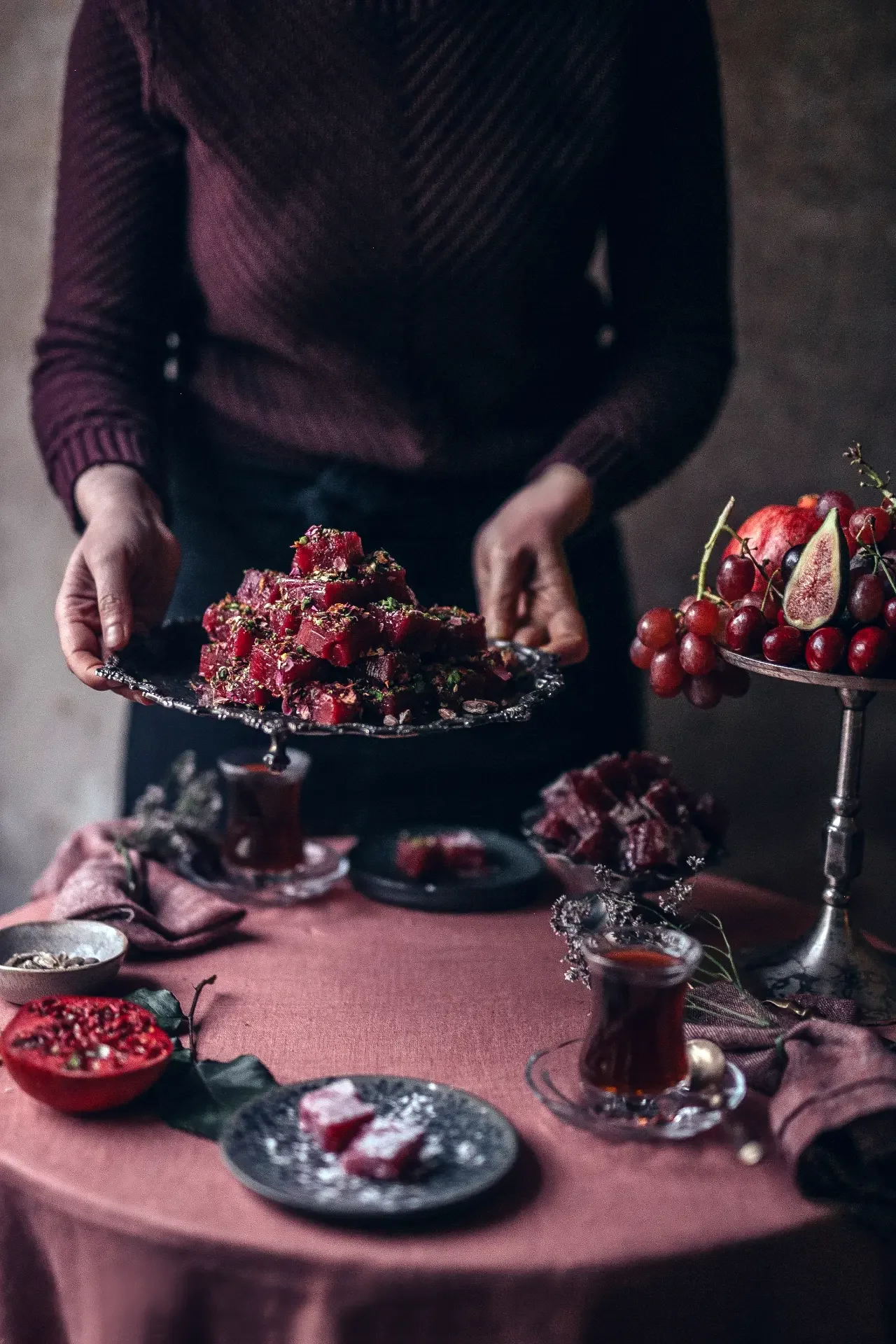 Serving handmade Turkish delight with black tea and seasonal flowers