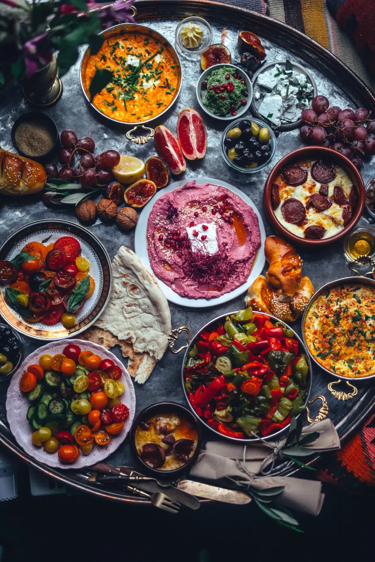 Traditional Turkish breakfast feast with Mediterranean spreads, vegetables and fruit garnishes