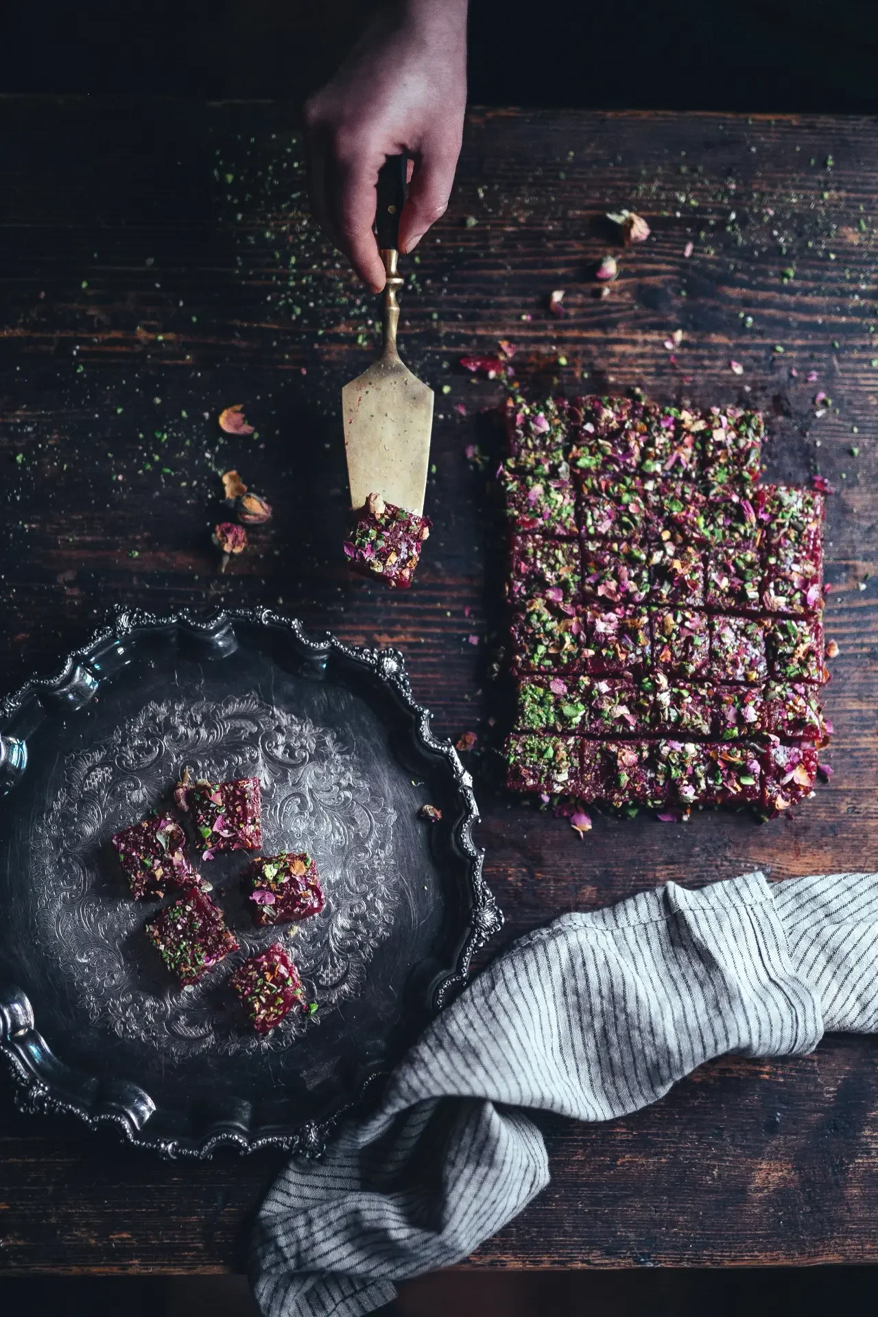 Traditional Turkish delight squares coated with pistachios and dried roses