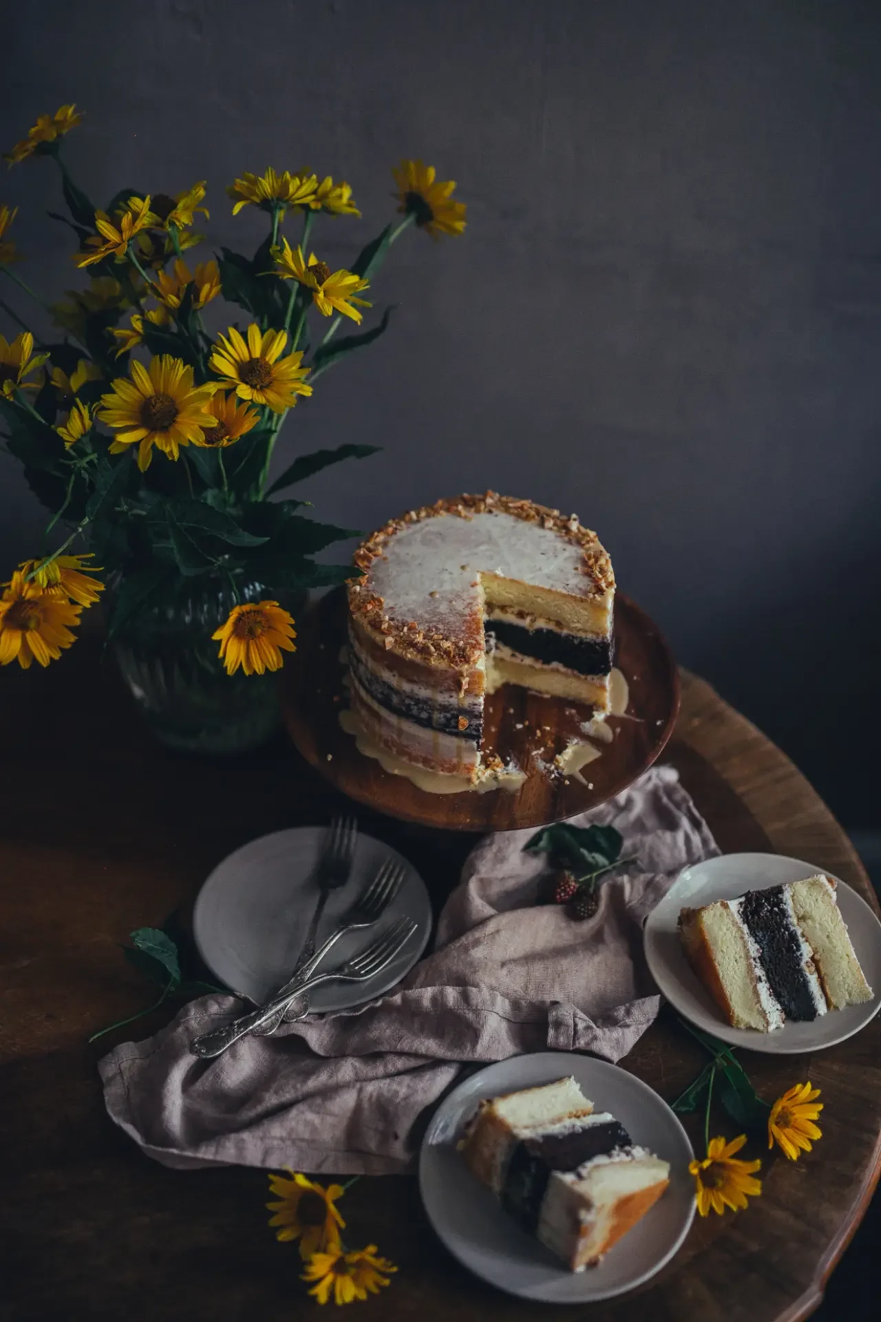 Tahini layer cake with cream filling and nuts topping decorated with yellow flowers