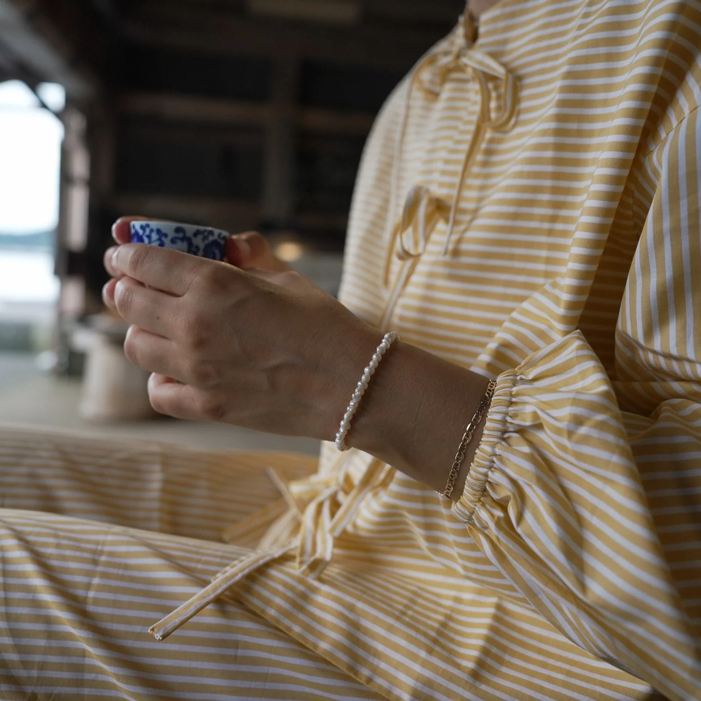 Meanwhile, let us have a sip of tea. 
The afternoon glow is brightening the bamboos, 
the fountains are bubbling with delight, 
the soughing of the pines is heard in our kettle. 
Let us dream of evanescence, and linger in the beautiful foolishness of