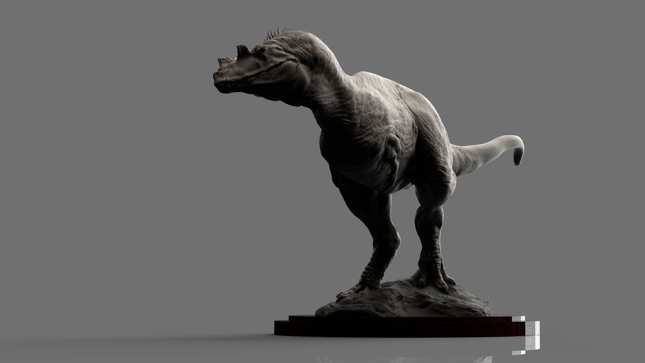 A detailed sculpture of a ceratosaurus dinosaur standing on a rocky base, displayed on a black platform, against a plain gray background.