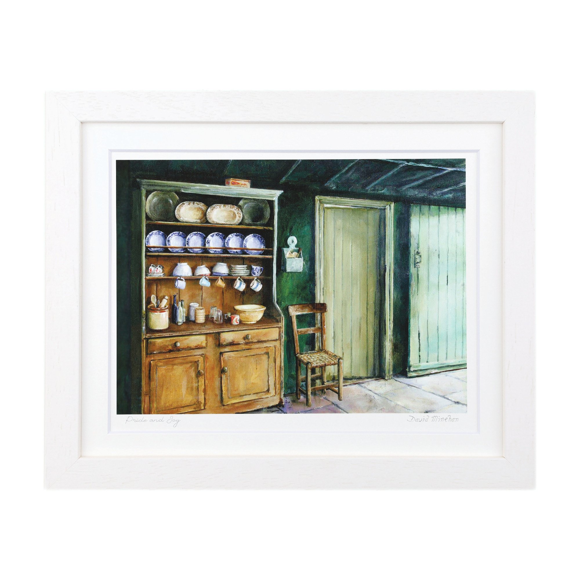Pride and Joy A pine dresser of blue-and-white plates and hanging cups against a deep green wall, with a rush-seated chair beside a painted door. Framed print by David Minehan.