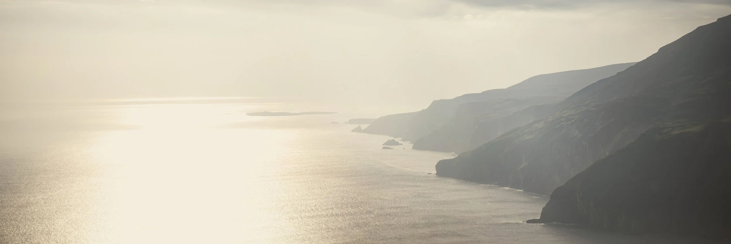 Misty Irish coast at golden light