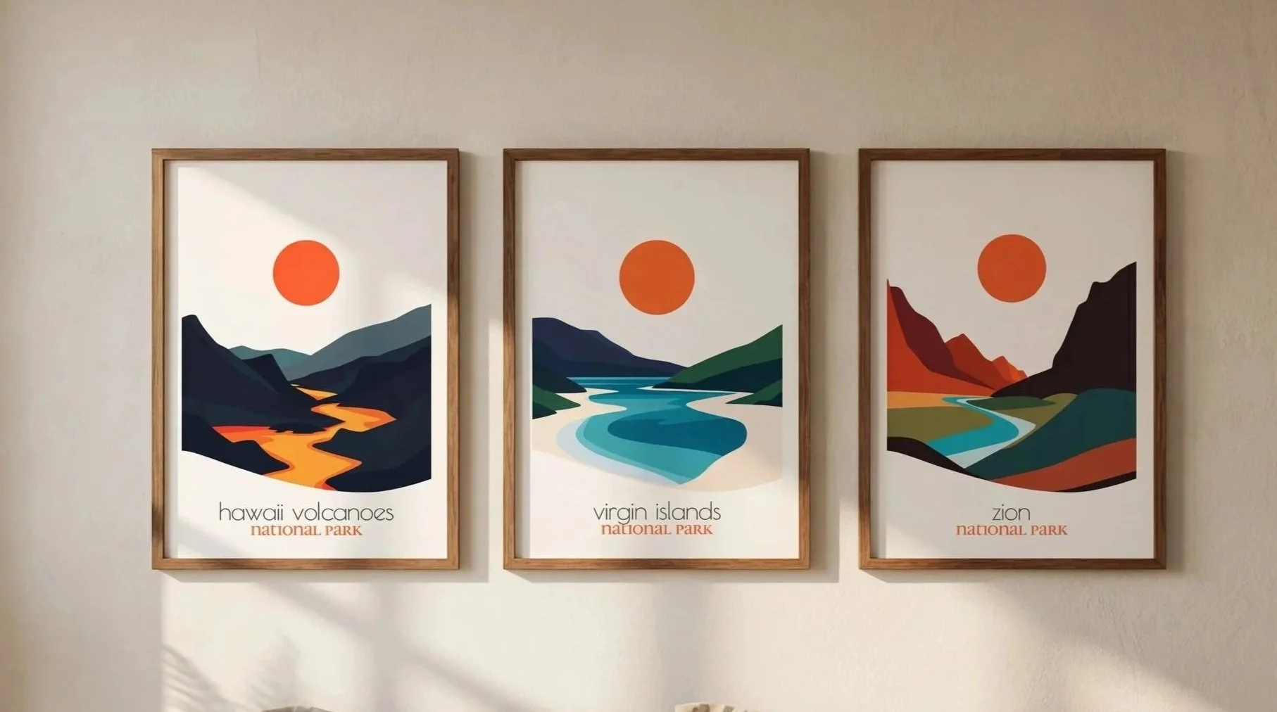 Three framed artistic posters of national parks, each showing a stylized landscape with a large orange sun, mounted on a light-colored wall. The left poster depicts Hawaii Volcanoes, the middle Virgin Islands, and the right Zion.
