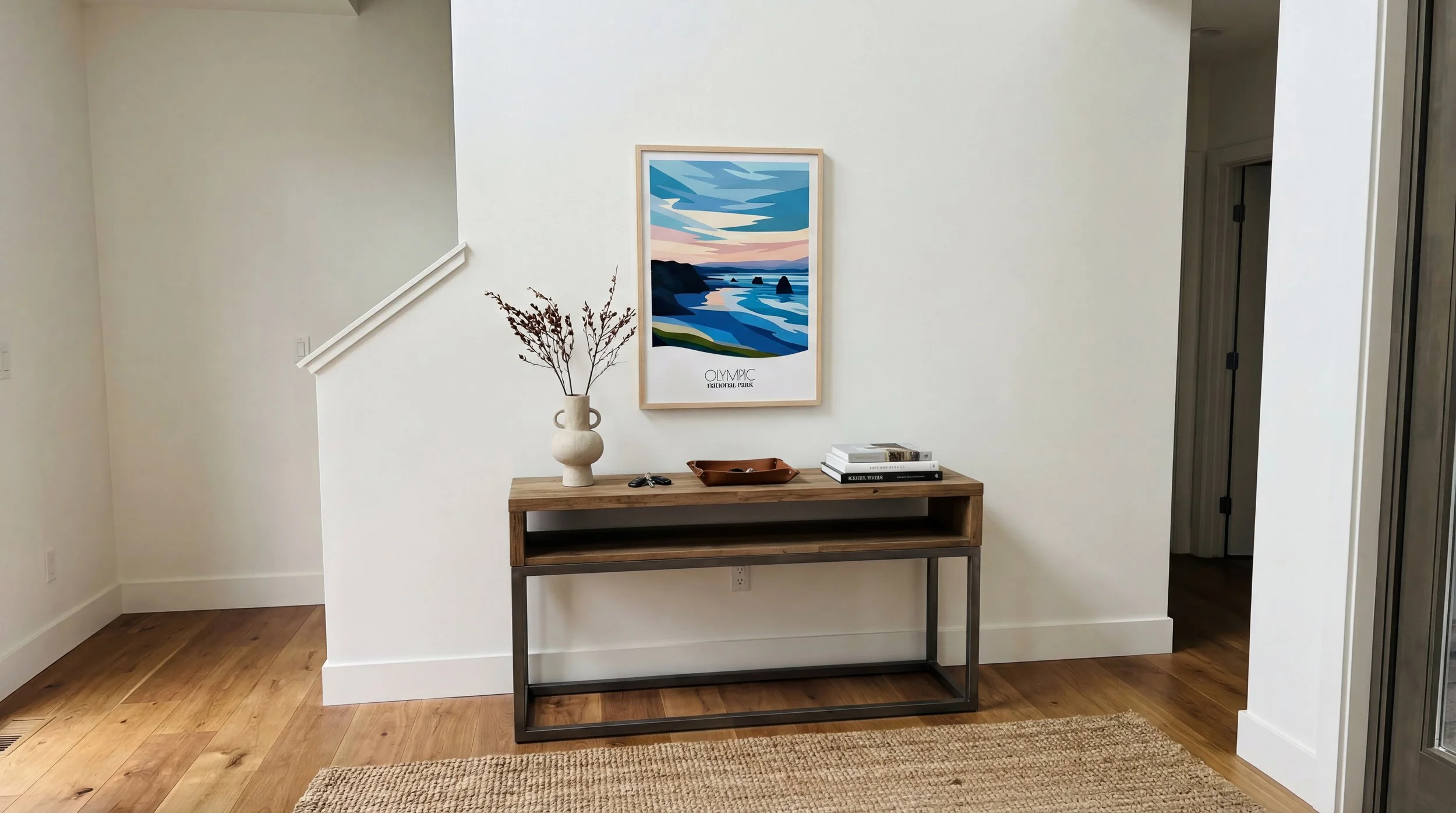 Minimalist abstract Olympic National Park poster in bright entryway hallway interior. Modern national park wall art with Pacific Northwest rainforest and mountain landscape in clean minimalist design.