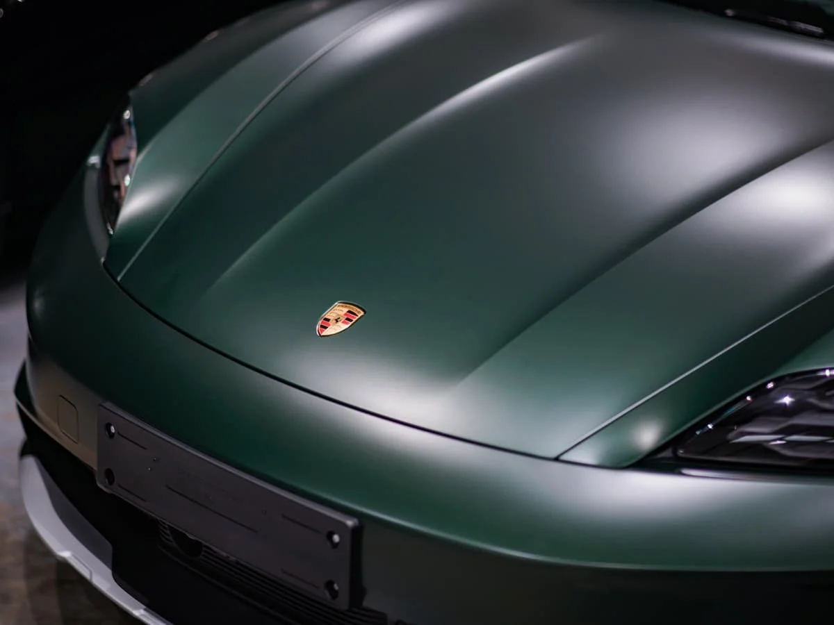 Close up of Porsche Taycan Cross Turismo bonnet in PTS Oak Green Metallic NEO with satin matte PPF installed by Lucid PPF Leeds