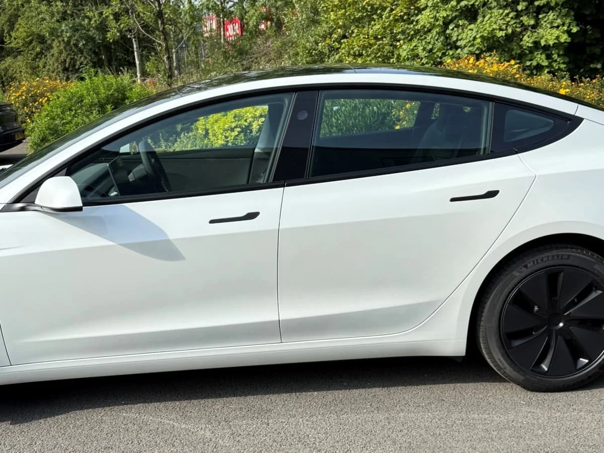 Tesla Model 3 side view in blue before window tints installed at Lucid PPF Leeds