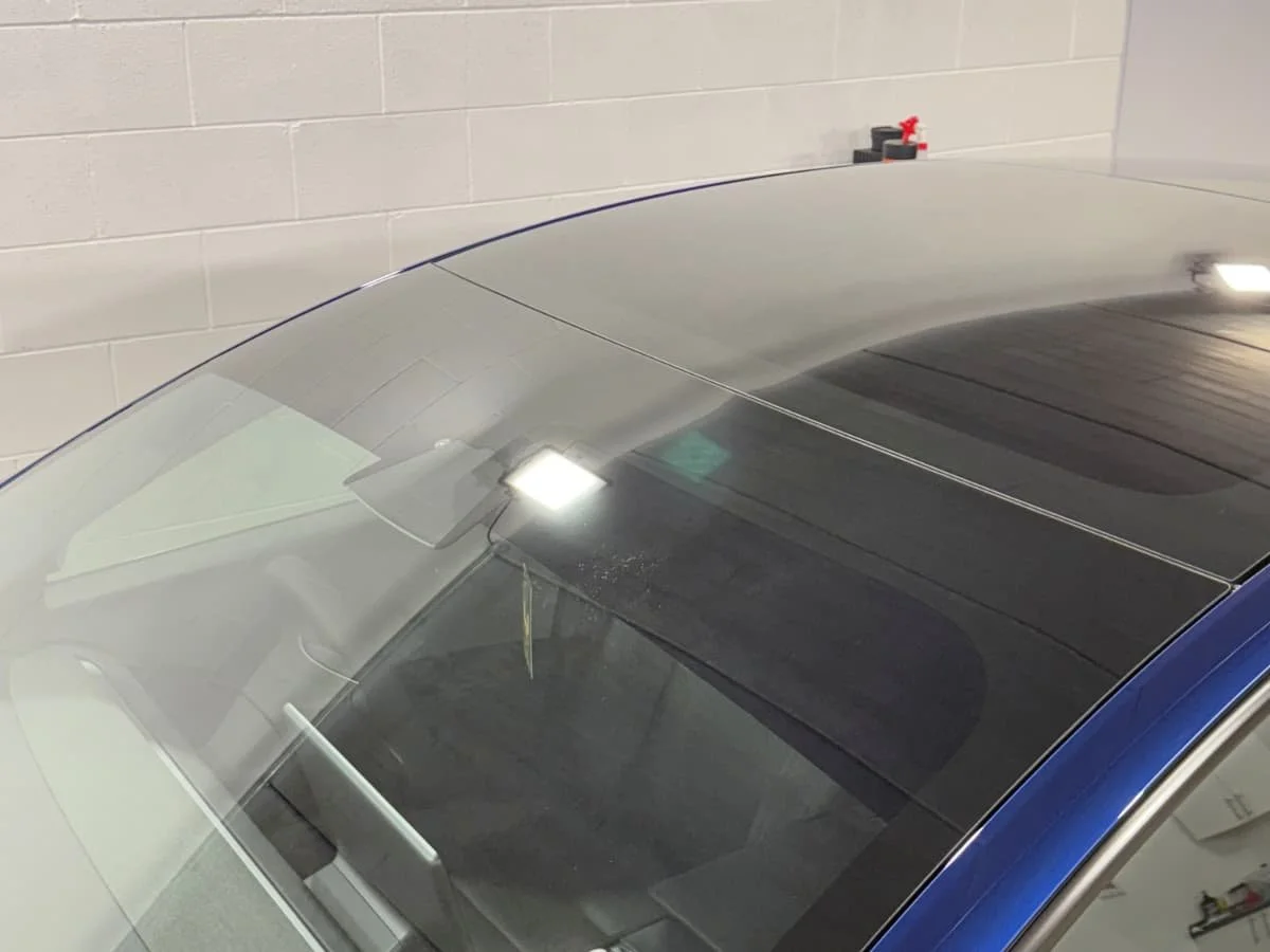 Tesla Model 3 front windscreen showing SunTek Carbon XP limo black sun strip installed by Lucid PPF Leeds