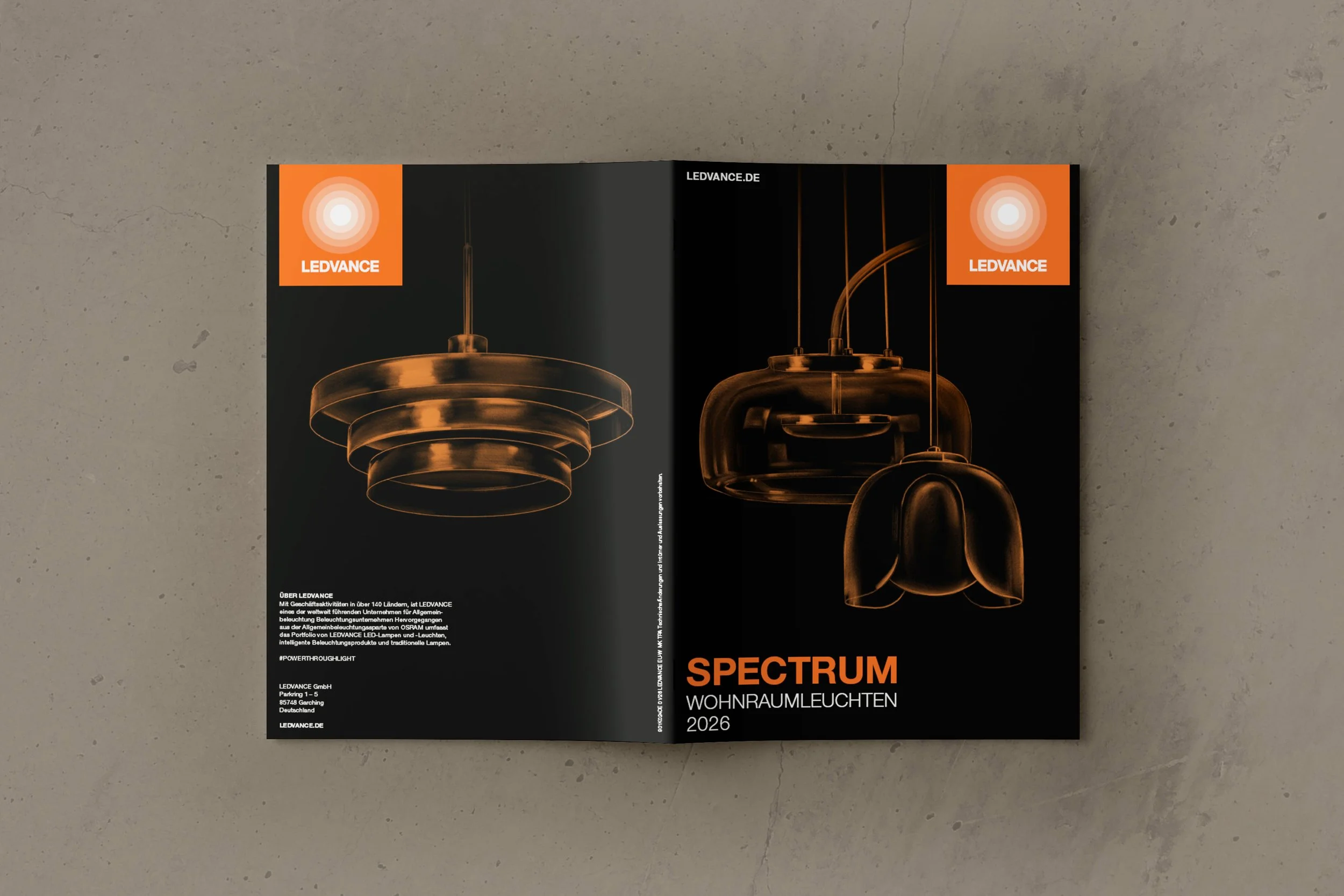 Brochure featuring modern LED pendant lights with orange and black design, advertising lighting products for home spaces, titled "Spectrum wohnraumleuchten 2026."