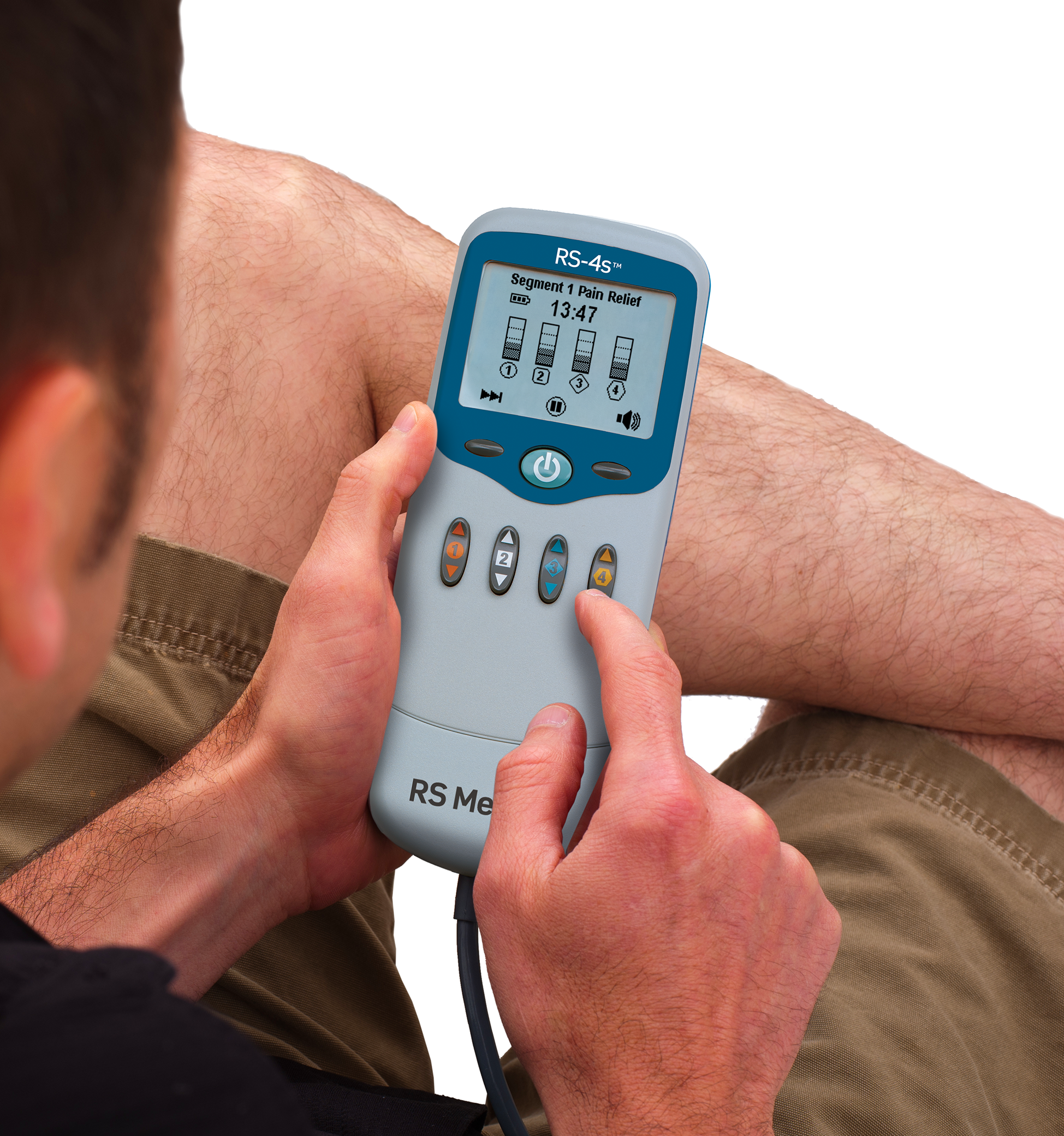 A person sitting down holding RS-4s device.