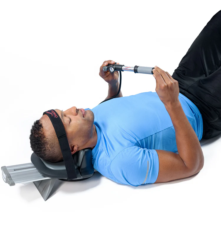 A man lying on a black with head in Pronex device.