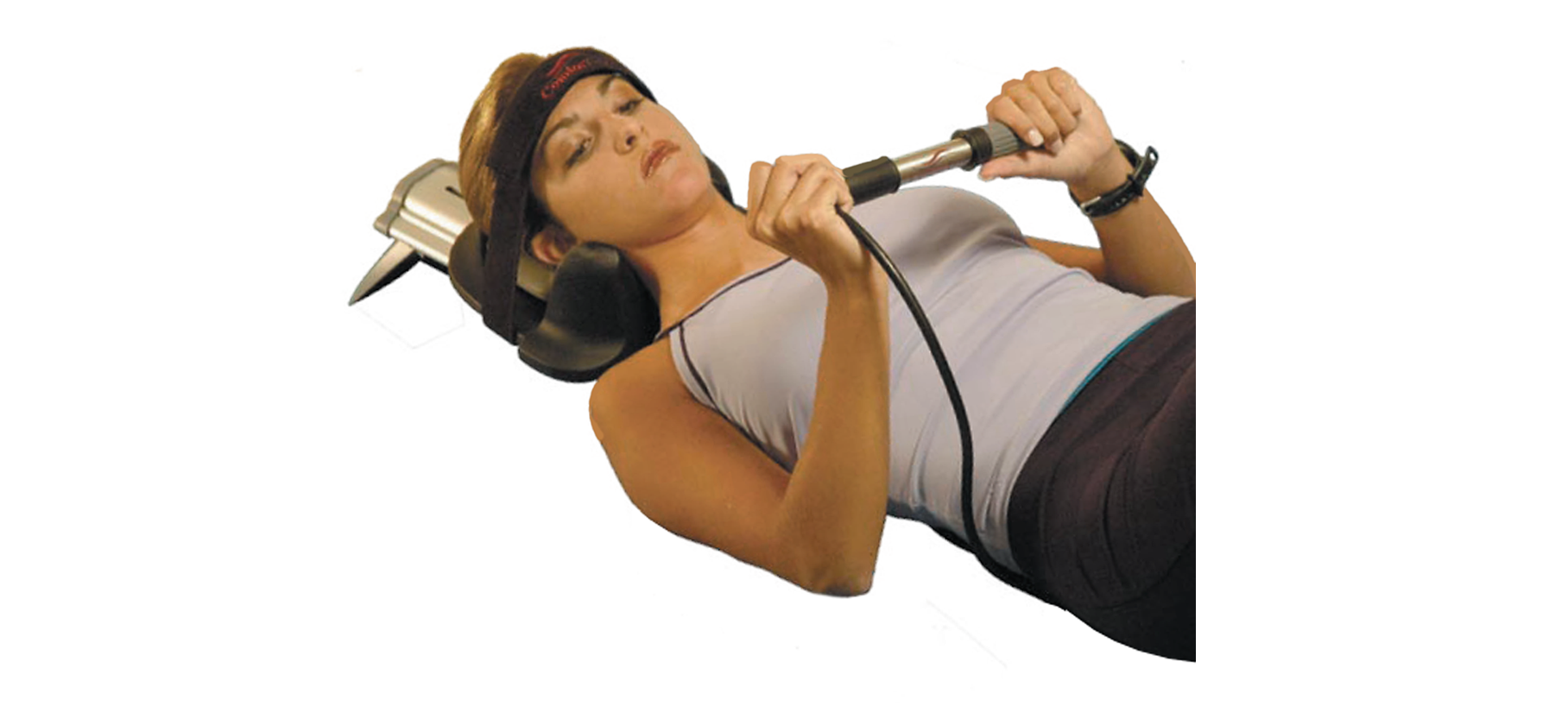 A woman lying on back with head in Pronex device.