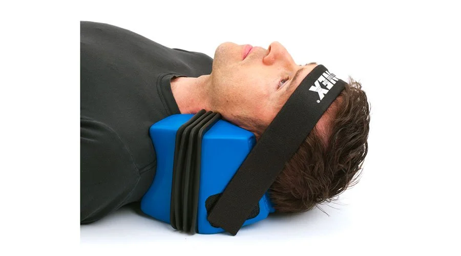 A man lying on his back with his head in ComforTrac device.