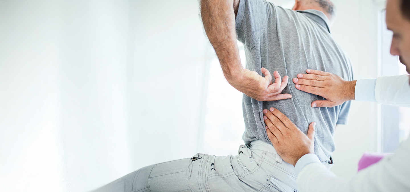 A person receiving medical treatment for lower back pain from a healthcare professional.