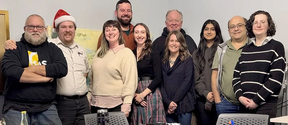 Group of Seattle Astronomical Society members smiling for a group photo indoors.