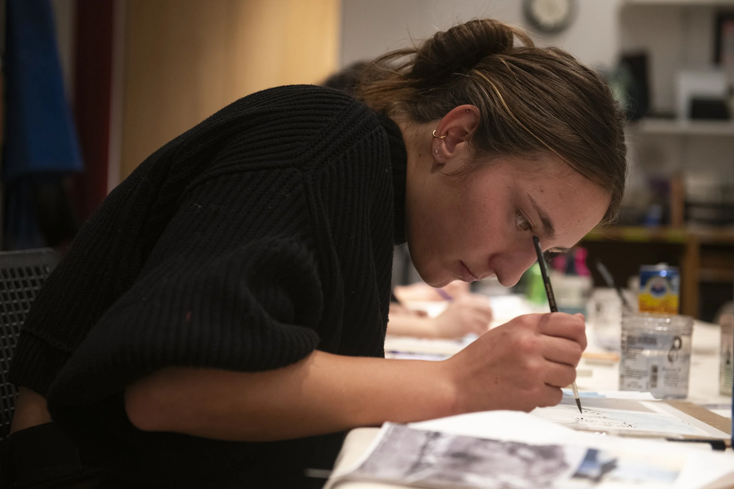 woman focused on watercolor painting