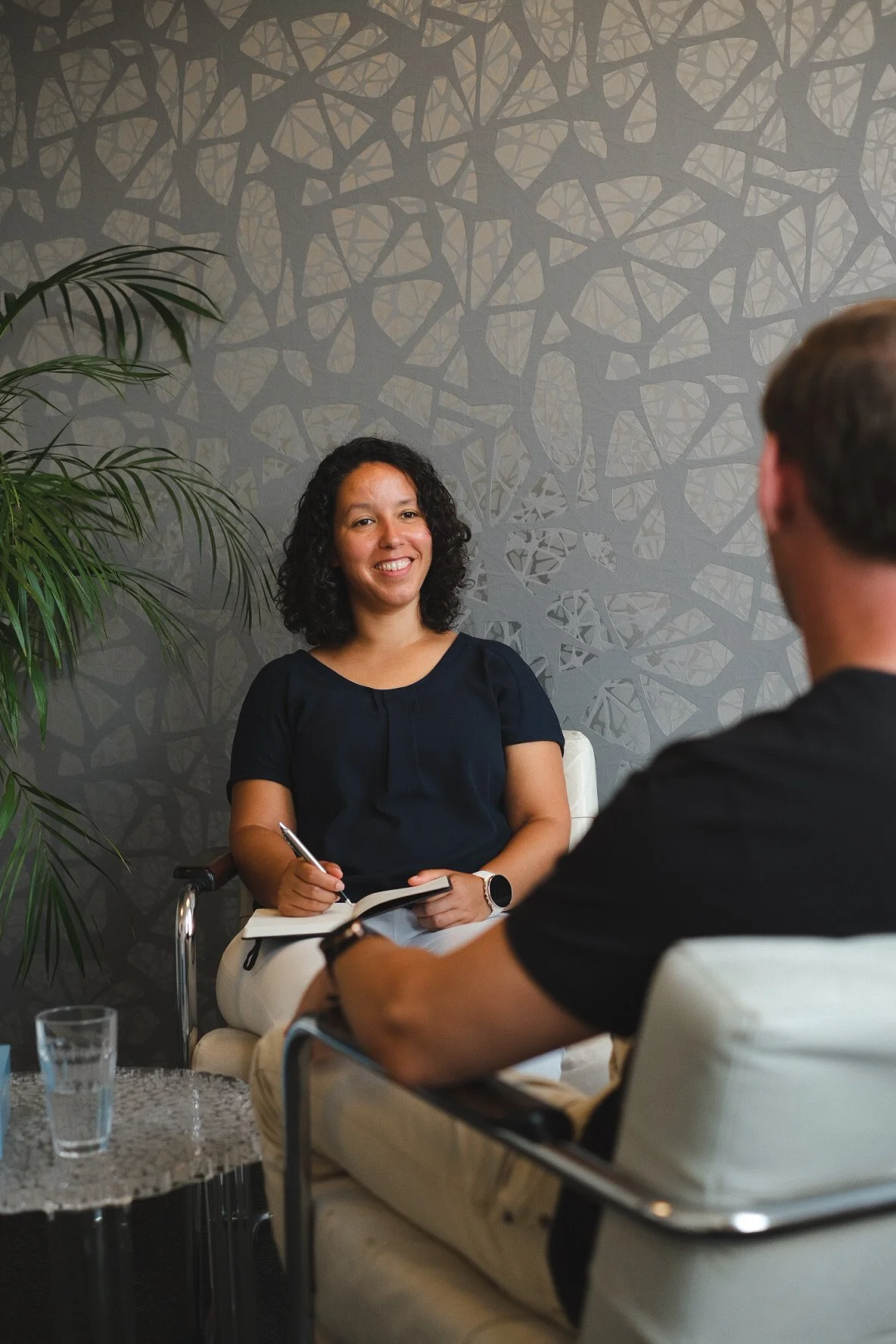 Sarah Getu from Flow Relating taking notes, sitting in a coaching session of Secure Attachment Coaching