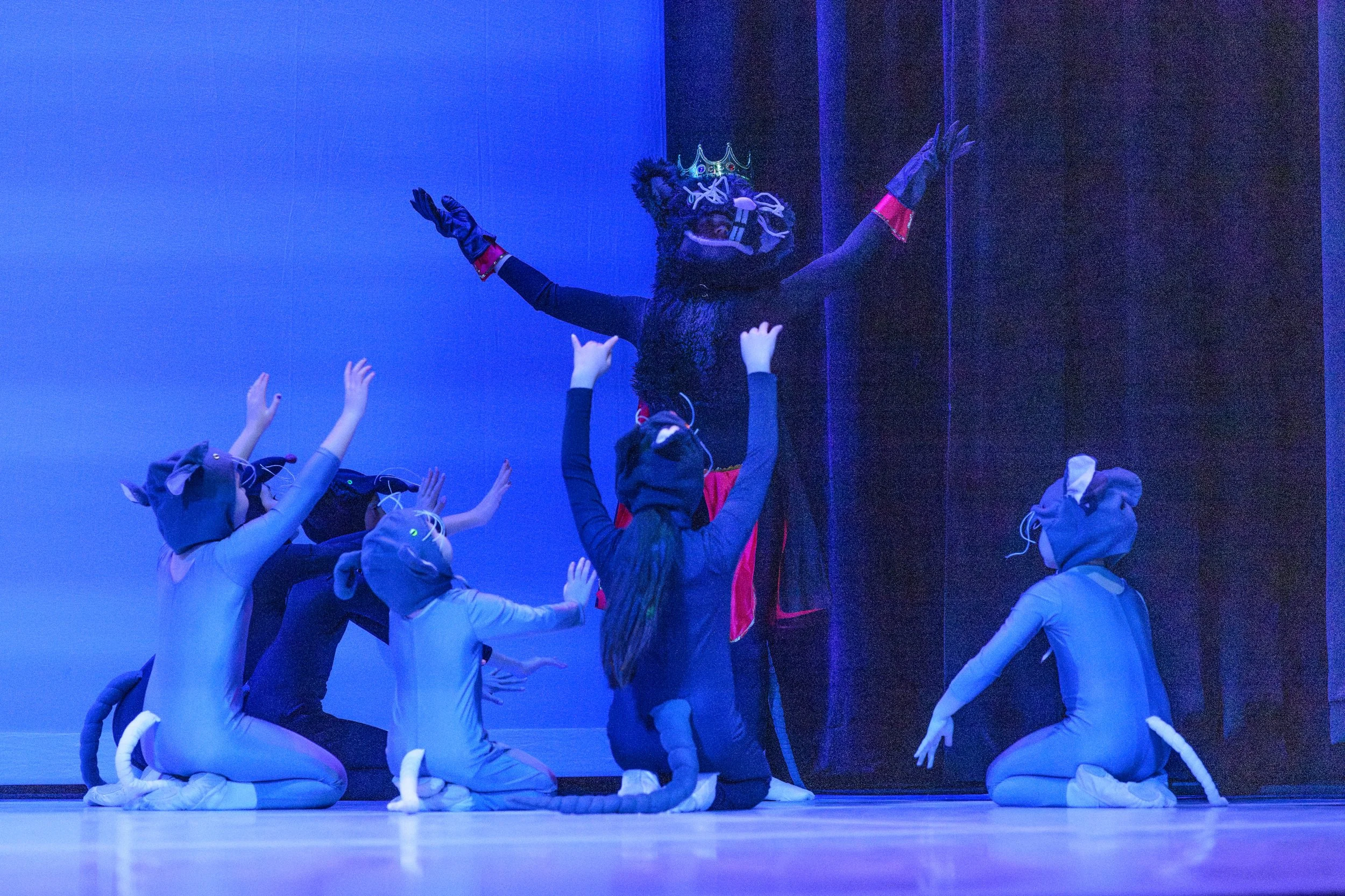 Children performing as mice and a crowned rat in The Nutcracker Ballet