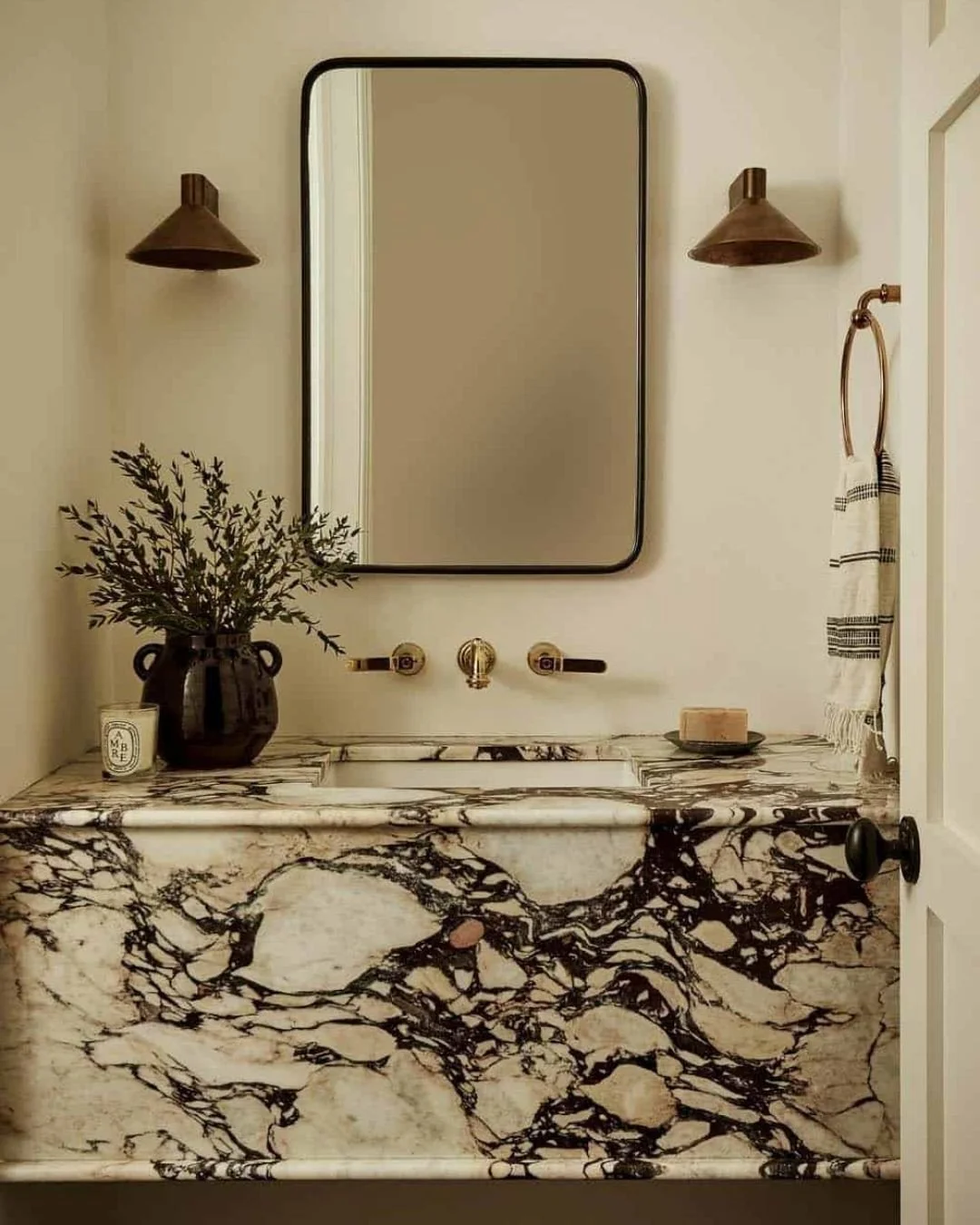 This powder room is proof that natural stone can be both dramatic and refined. Perfect for shorter days and cozy evenings, we love how the marble brings warmth, movement, and a touch of luxury.⁠
⁠
📸 Design by @beccainteriors⁠
⁠
#naturalstone #marble