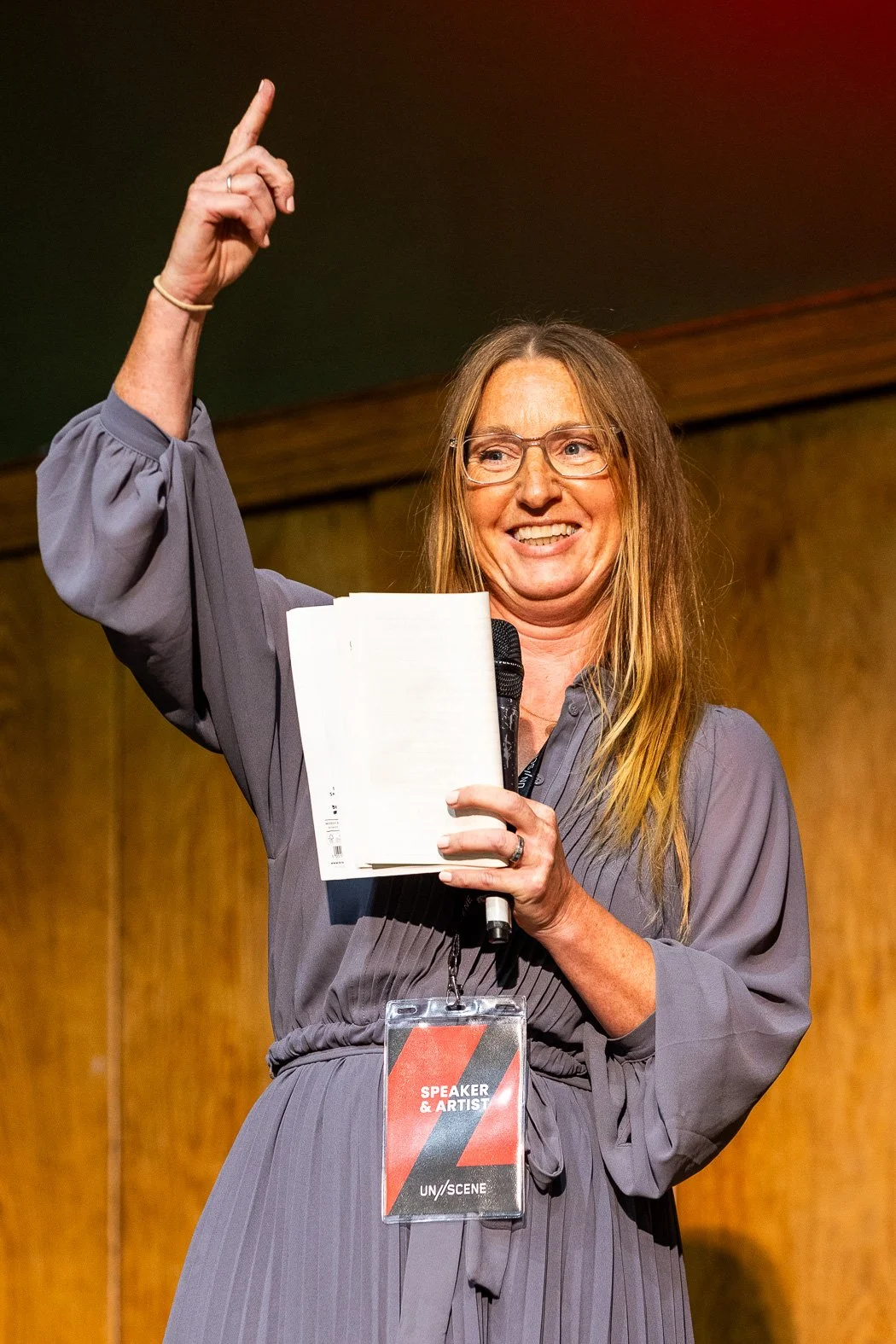 Our poet in residence points at the words above the main stage that say 'to thine self be true'