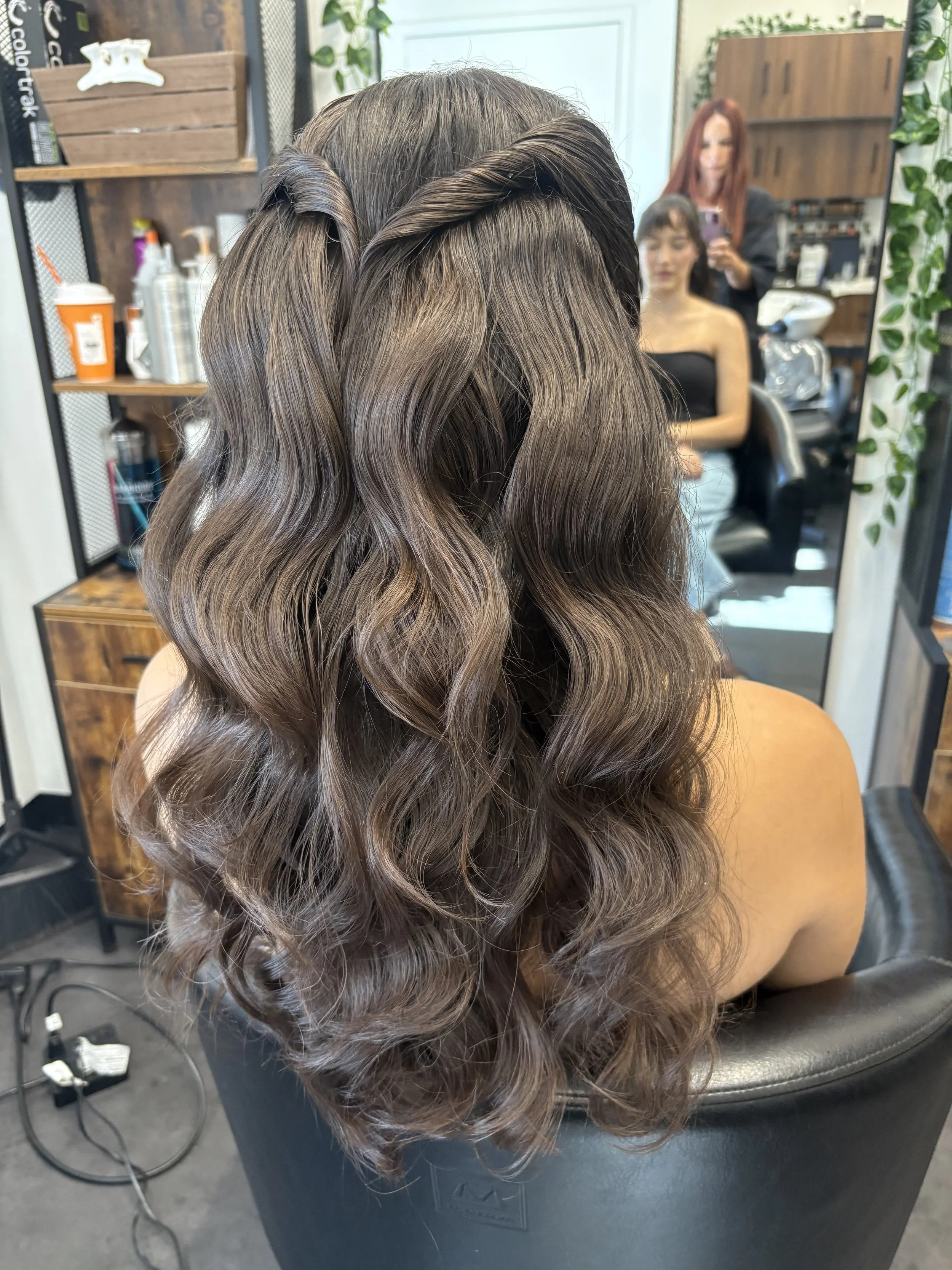 Philadelphia bride trialing a half up bridal style with waves and side twist