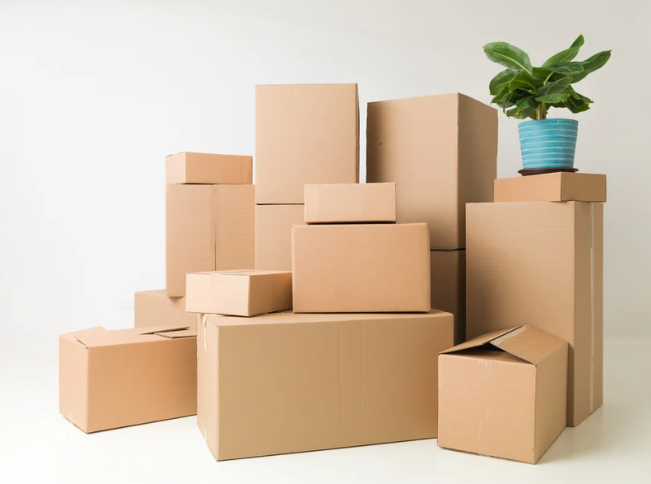 A variety of moving box sizes stacked and ready for packing, illustrating the Home to Home Services guide to choosing the right box size