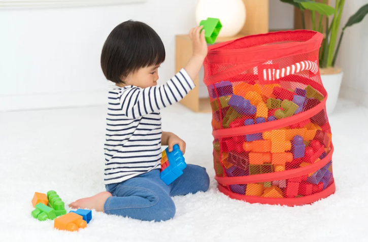 A child helping sort and donate toys as part of a compassionate decluttering process guided by Home to Home Services