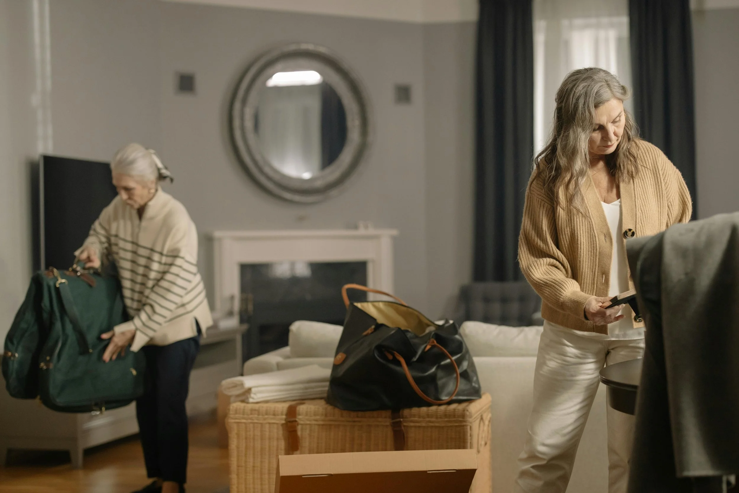An adult child helping an aging parent sort through belongings during a compassionate downsizing process, supported by Home to Home Services in Richmond, VA