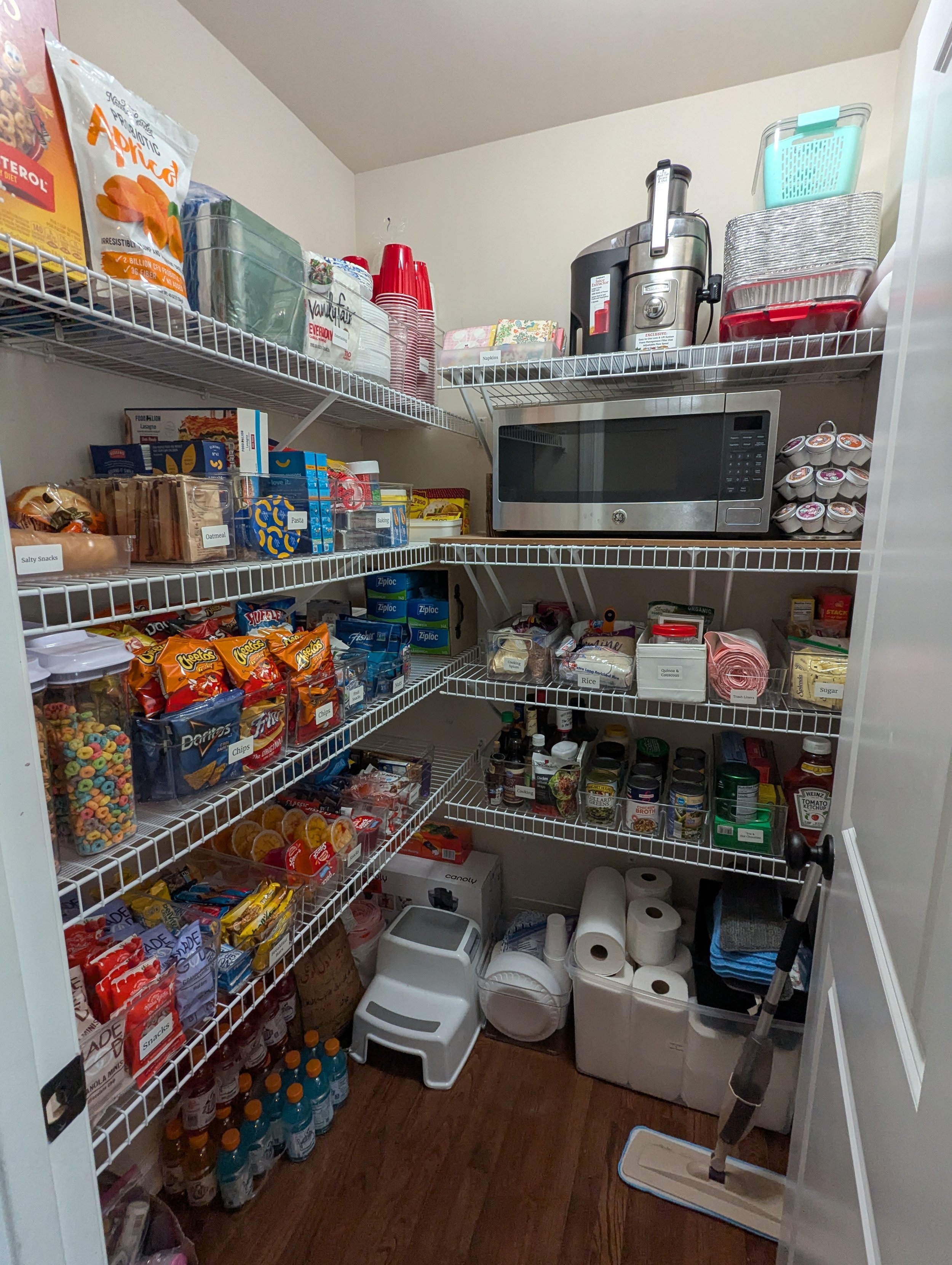 A beautifully organized pantry with labeled bins, clear containers, and neatly arranged shelves, representing professional kitchen organizing services by Home to Home Services in Richmond, VA
