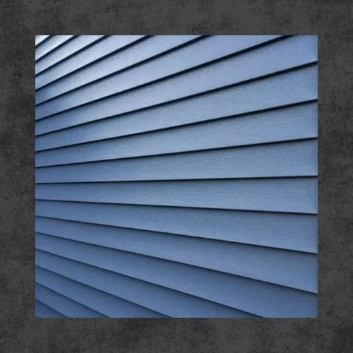A close-up view of blue horizontal vinyl siding on a building.