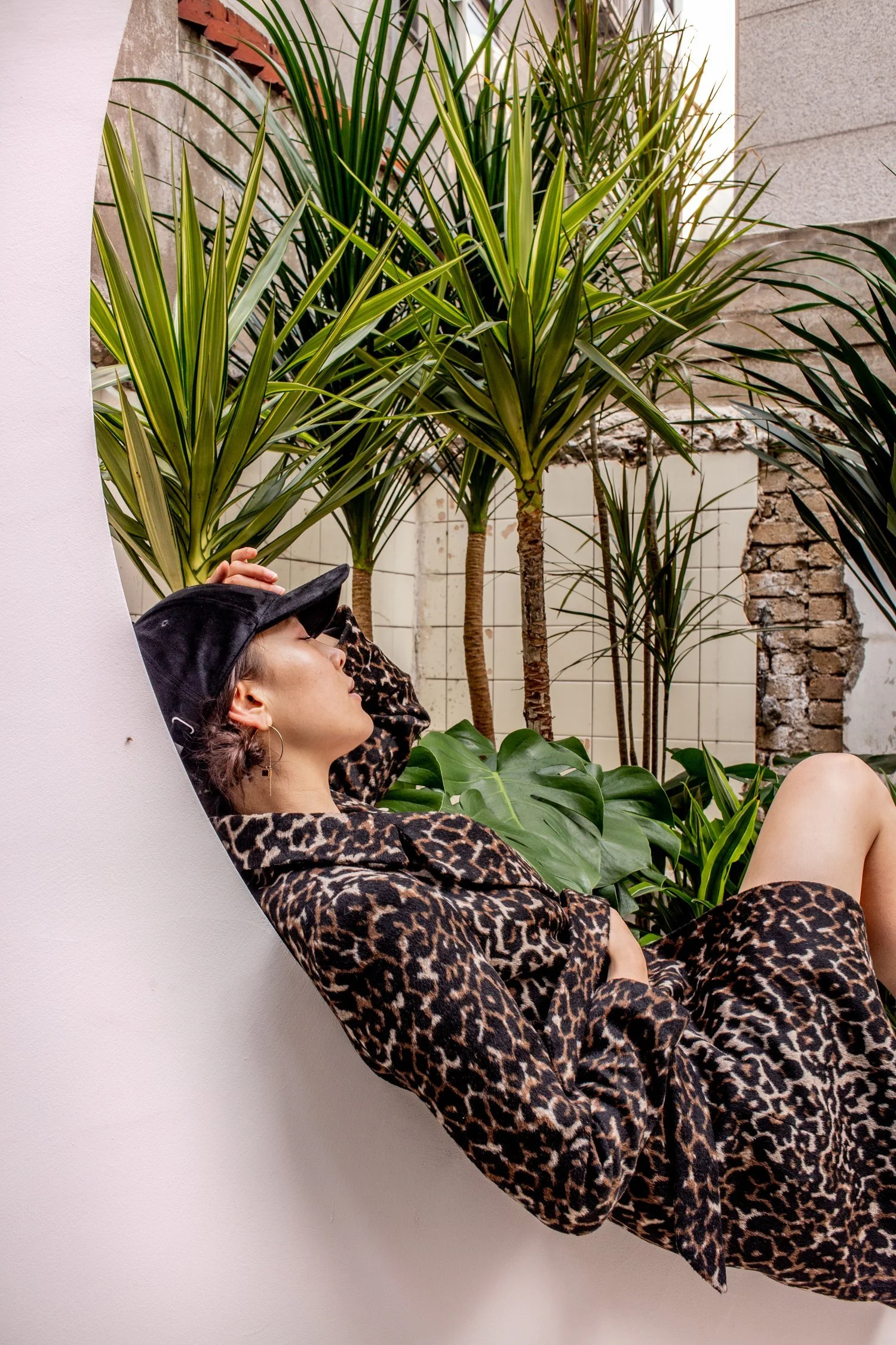 beautiful half korean girl in a cheetah print coat and a black cap