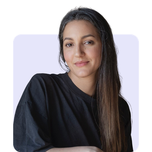 A woman with long dark hair wearing a black shirt against a white background.