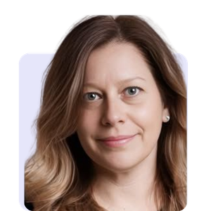 Close-up of a woman with light brown hair and blue eyes, smiling at the camera.