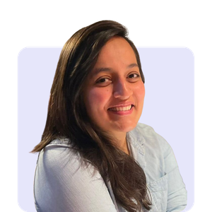A woman with long dark hair smiling, wearing a light-colored top, against a plain background.