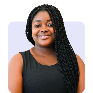 A woman with dark braided hair wearing a sleeveless black top, smiling at the camera.