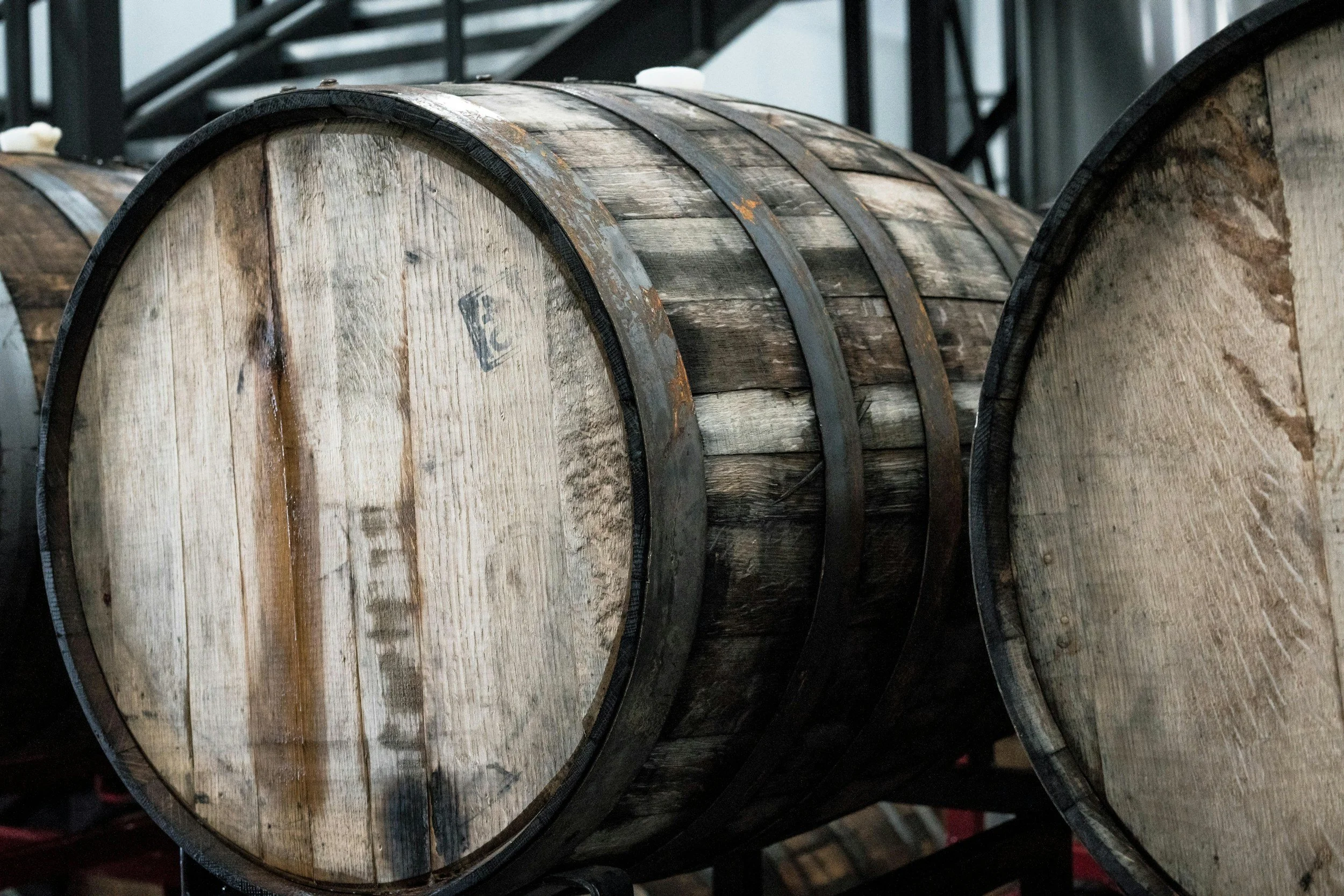 Close-up of wooden barrels in a distillery or brewery.
