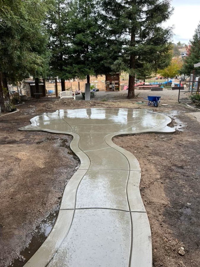 Concrete path leading to concrete circular patio