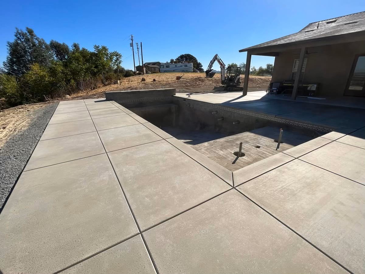 Concrete sidewalk around pool