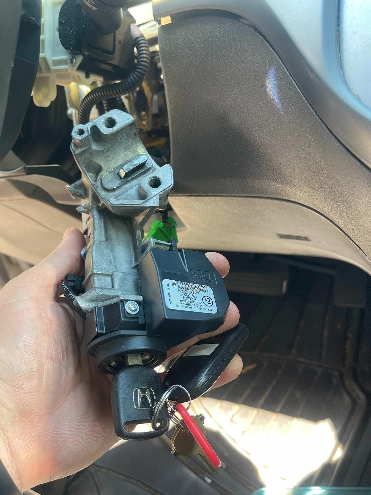 Real GBP photo showing a locksmith at a vehicle door lock or ignition.