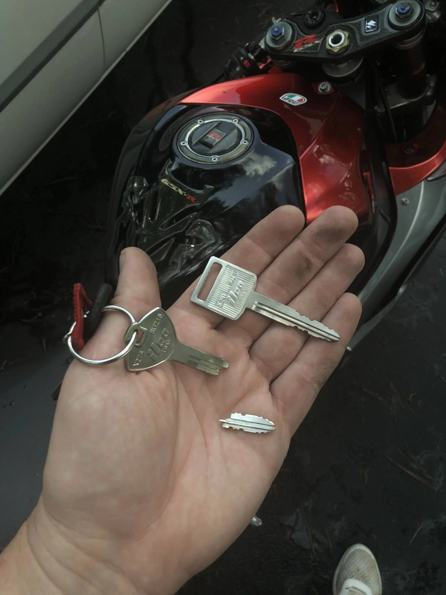 Real GBP photo showing a locksmith working at a motorcycle ignition or lock.