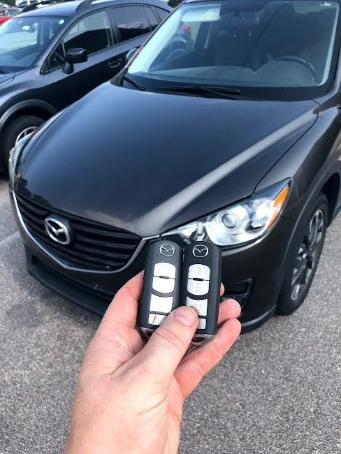 Real GBP photo showing car keys, fobs, key cutting or a technician replacing a vehicle key.