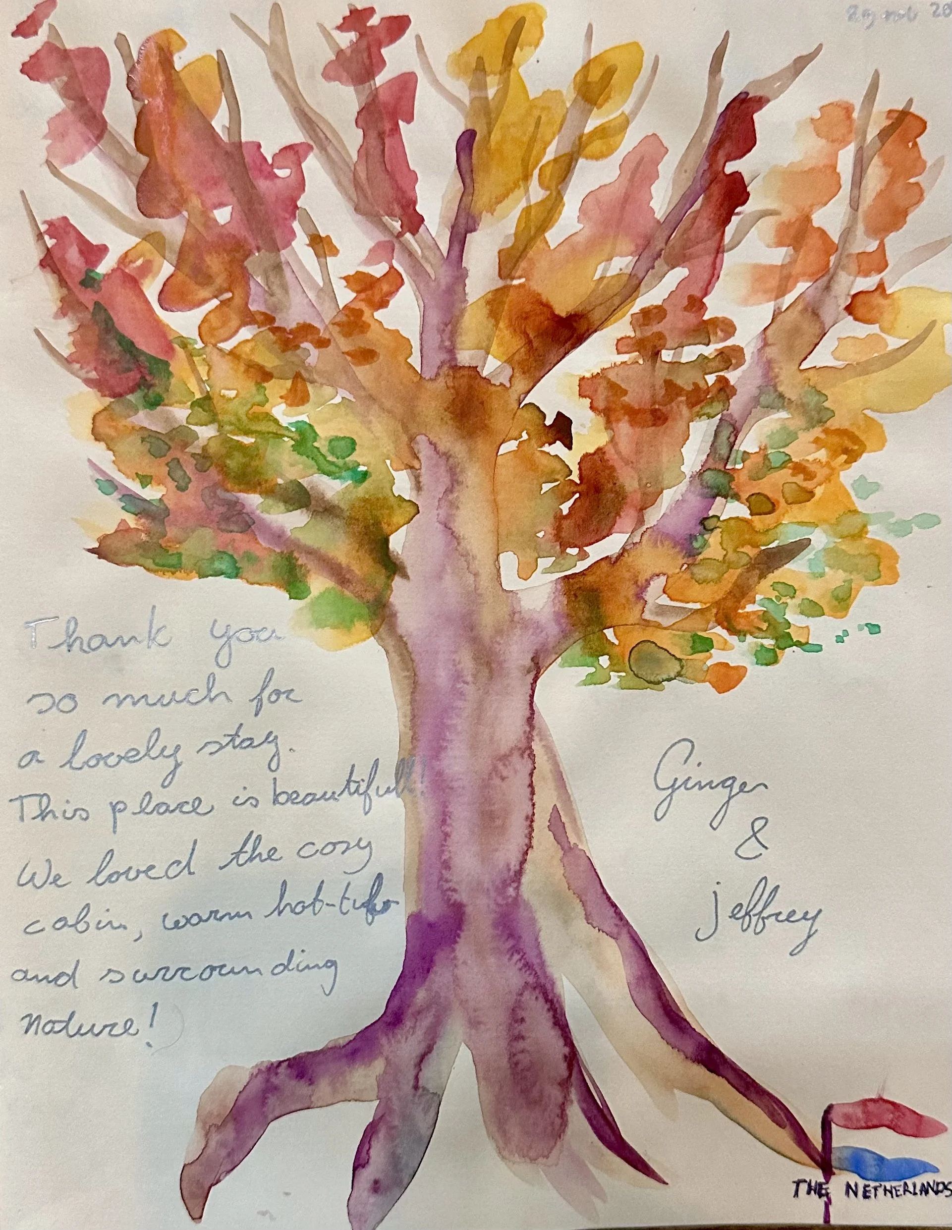 A colorful watercolor painting of a tree with vibrant orange, pink, purple, and green leaves. Accompanying handwritten note expresses gratitude for a lovely stay and appreciation for the cozy cabin in the Netherlands.