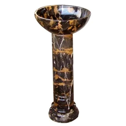 Marble pedestal with bowl on top.