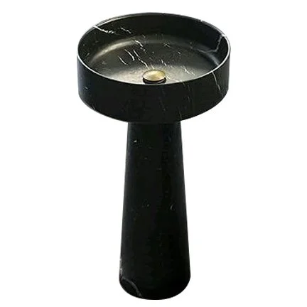 Black pedestal sink with a round basin and a single faucet hole