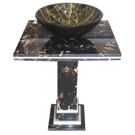 Marble side table with a gold-accented black bowl on top.