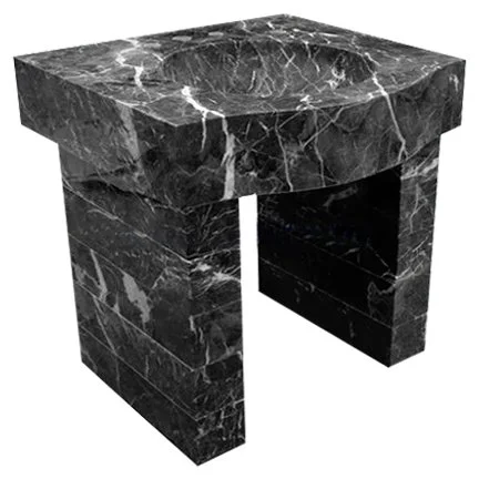 A black marble fireplace mantle with white veining.