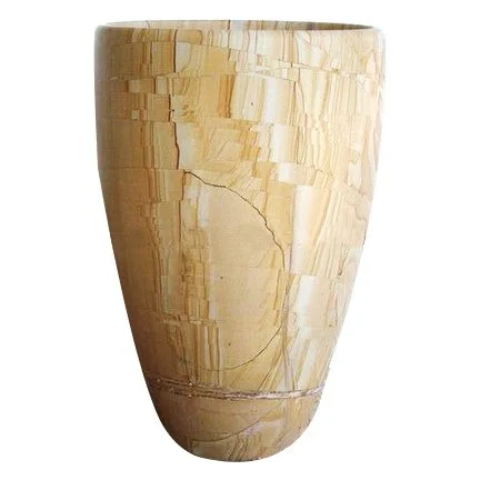 A tall, cylindrical ceramic vase with a textured, layered pattern in beige and cream tones.